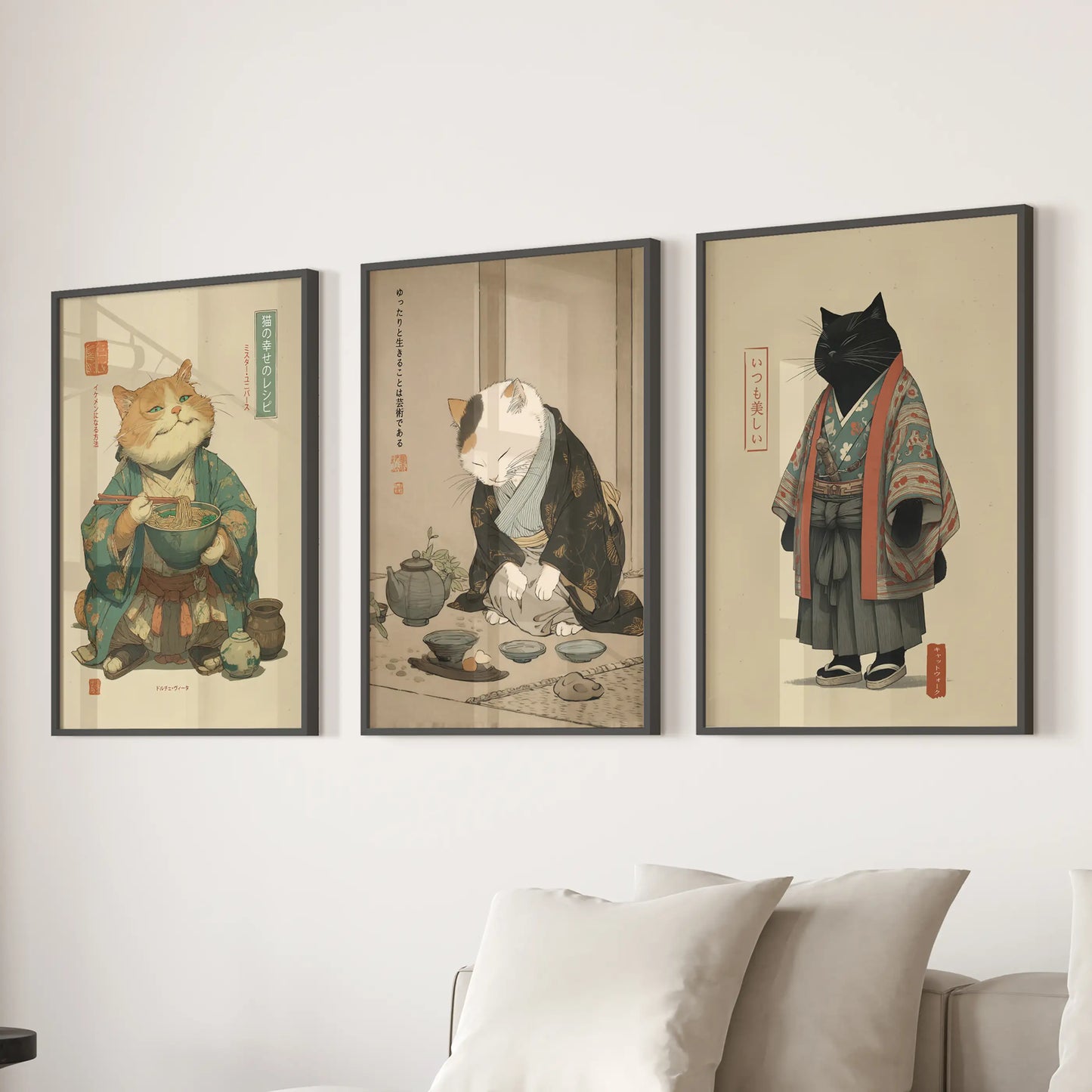 Three black-framed Japandi cat prints line the wall behind the living-room sofa, their calm kitchen scene lending quiet, modern balance.