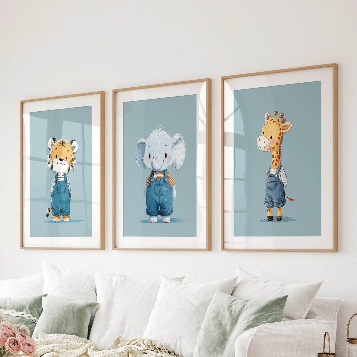 A trio of blue jungle animal artworks in solid oak frames with mats lines the family room wall behind the couch, bringing friendly color.