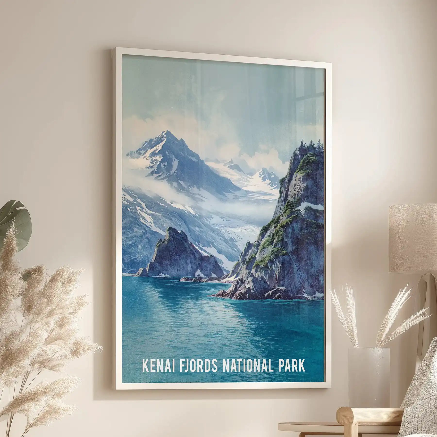 A coastal cliffs poster in a white frame brightens the lounge, resting near the reading chair with a quietly rugged calm.