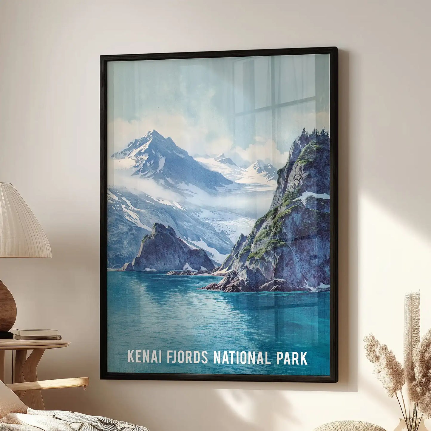 A Kenai Fjords National Park poster anchors the living room wall, its black frame centered above the window beside the side chair.
