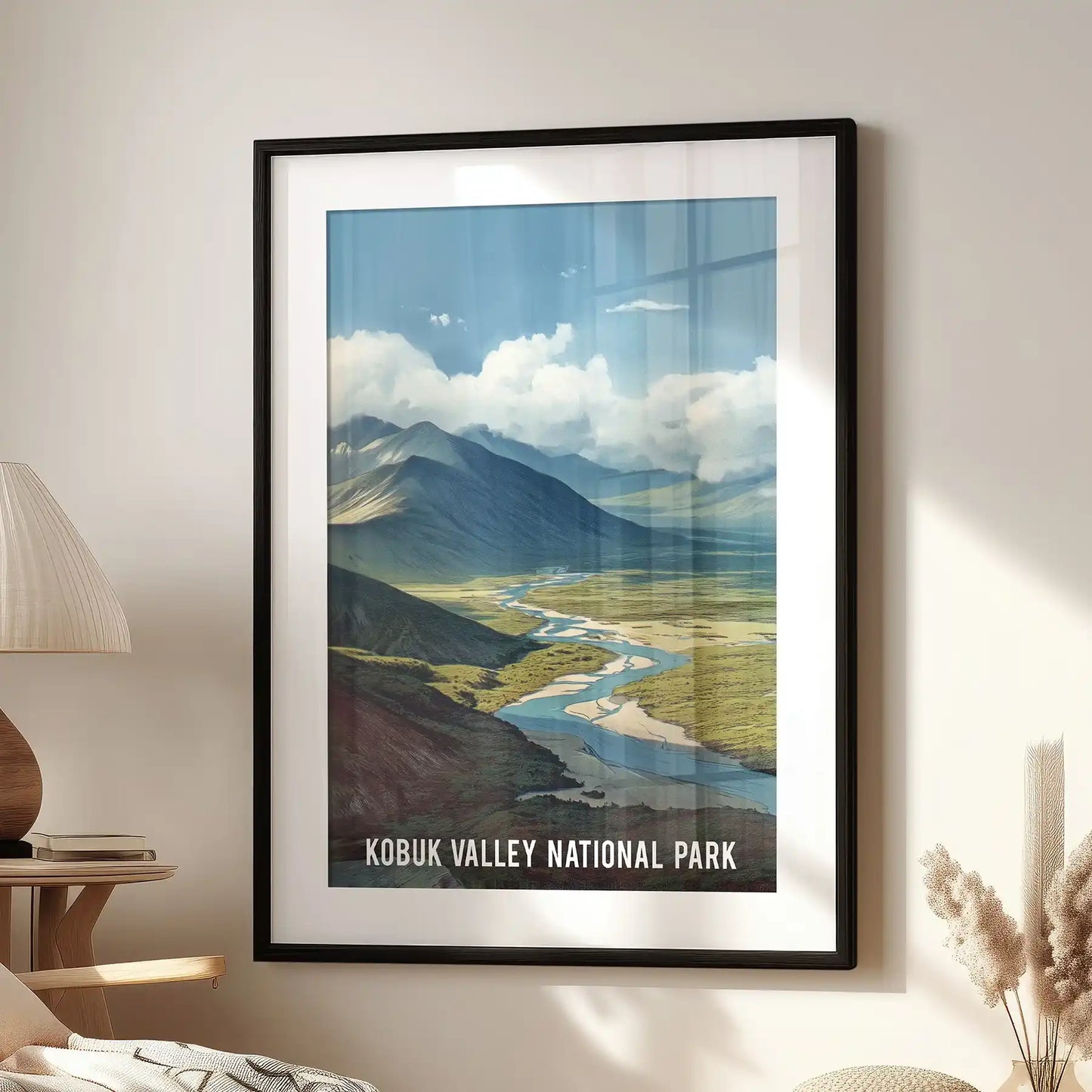 Kobuk Valley National Park standalone artwork, in a black frame with a white mat, sits above the living room armchair to anchor the wall with Alaskan depth.