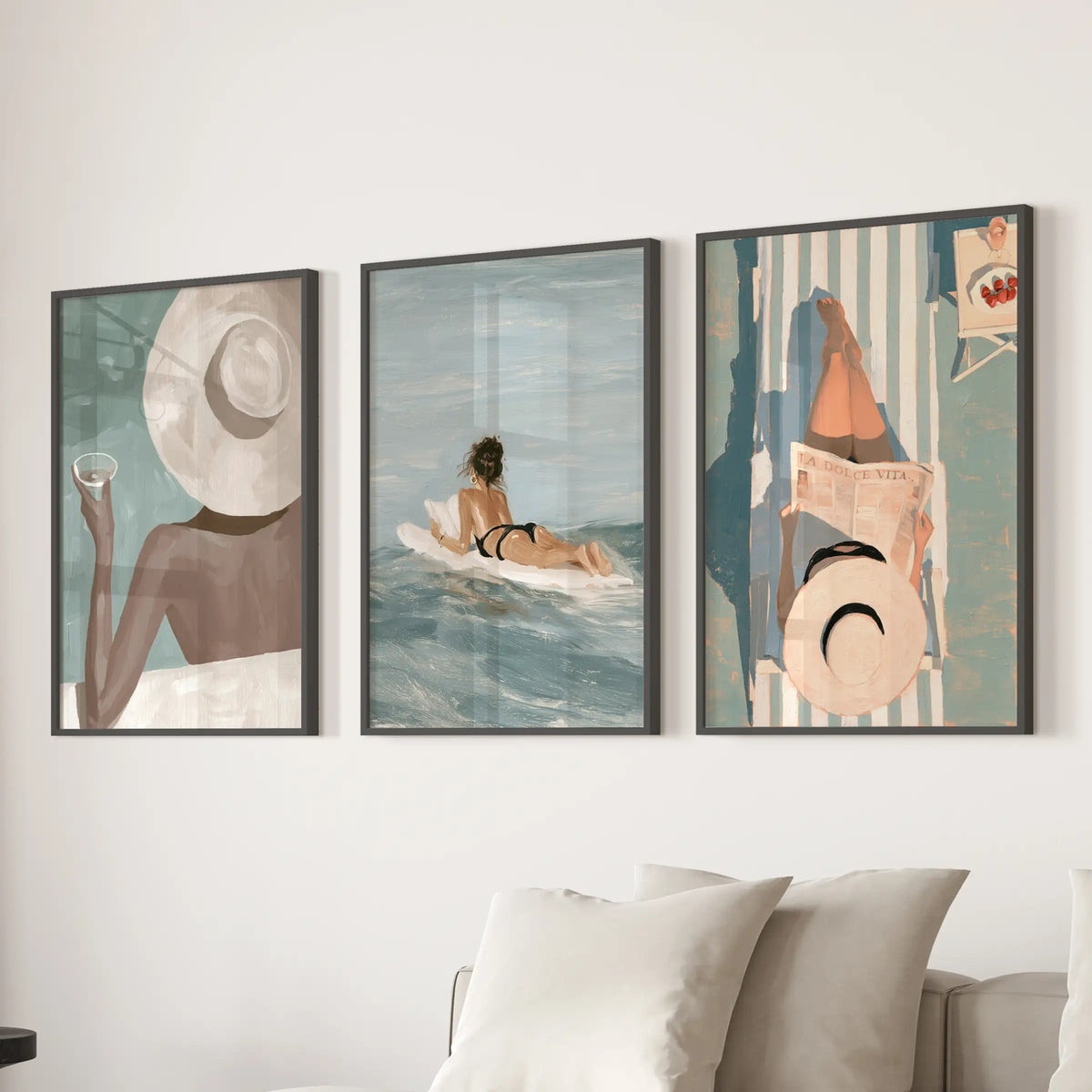 La Dolce Vita set of 3 wall art prints appears in black frames on a living room wall behind the couch.