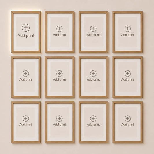 Custom wall art builder displaying twelve empty natural wood frames arranged in four columns and three rows. Build a large gallery wall by selecting matching art prints.
