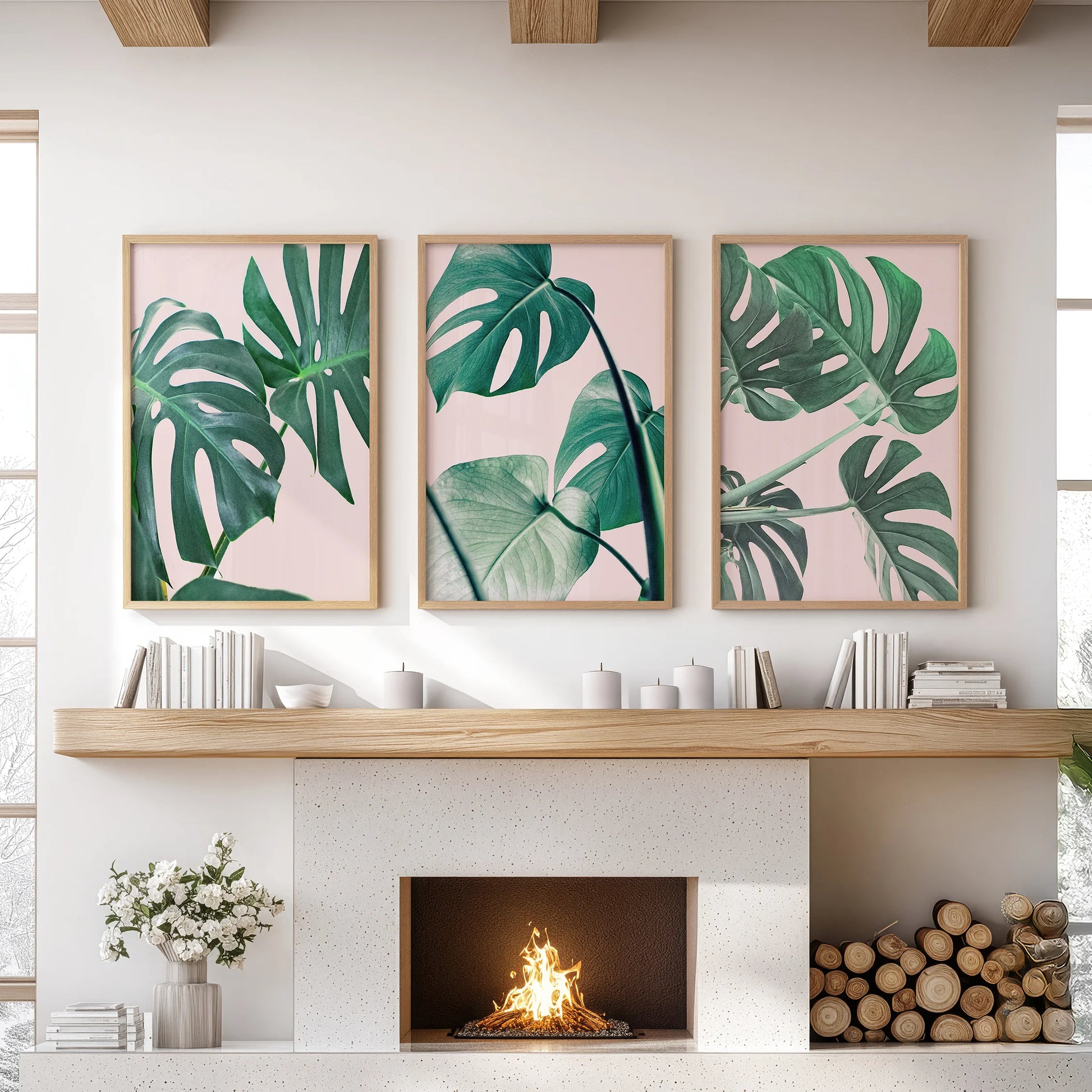 Tropical pink and green foliage 3-piece artwork set, thin wood framed, brings relaxed wall art to the family room, styled neatly over the mantelpiece.