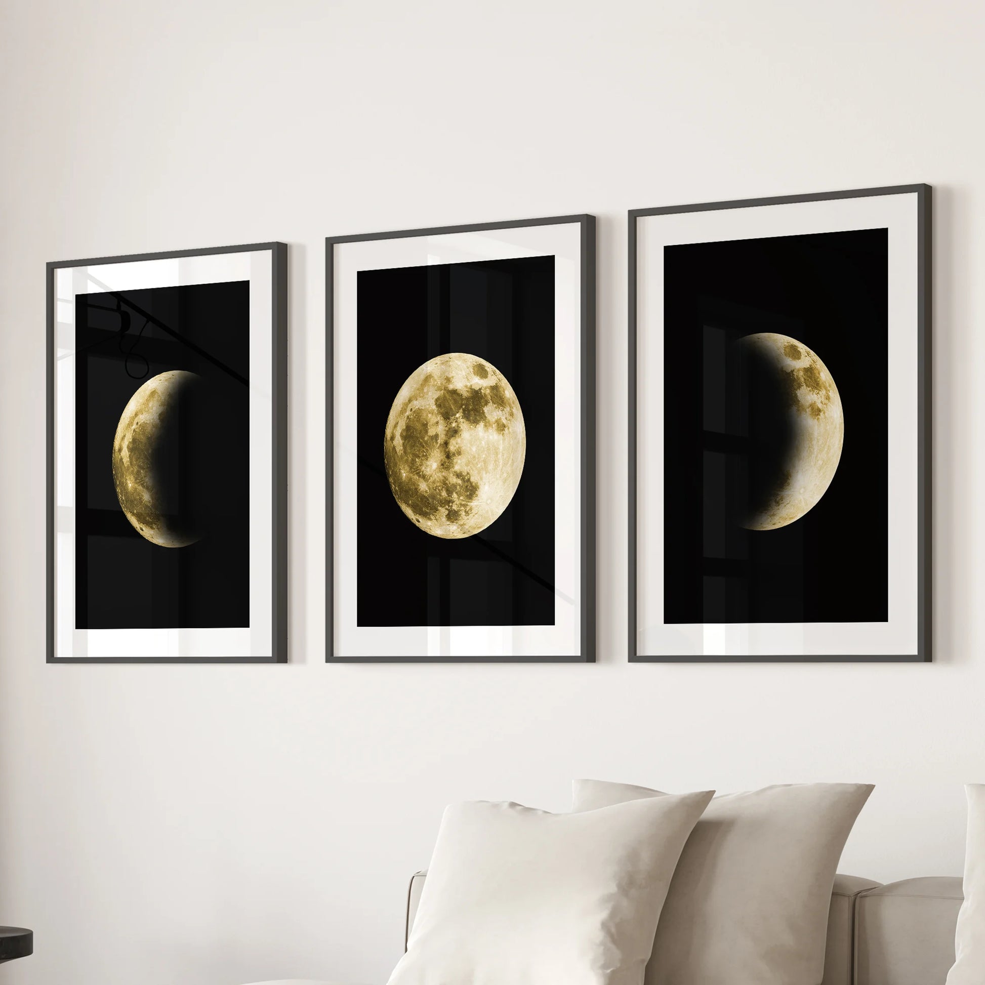 A 3-piece wall hanging of gold-and-black moons in matted frames anchors the family room above the sofa with an understated modern glow.