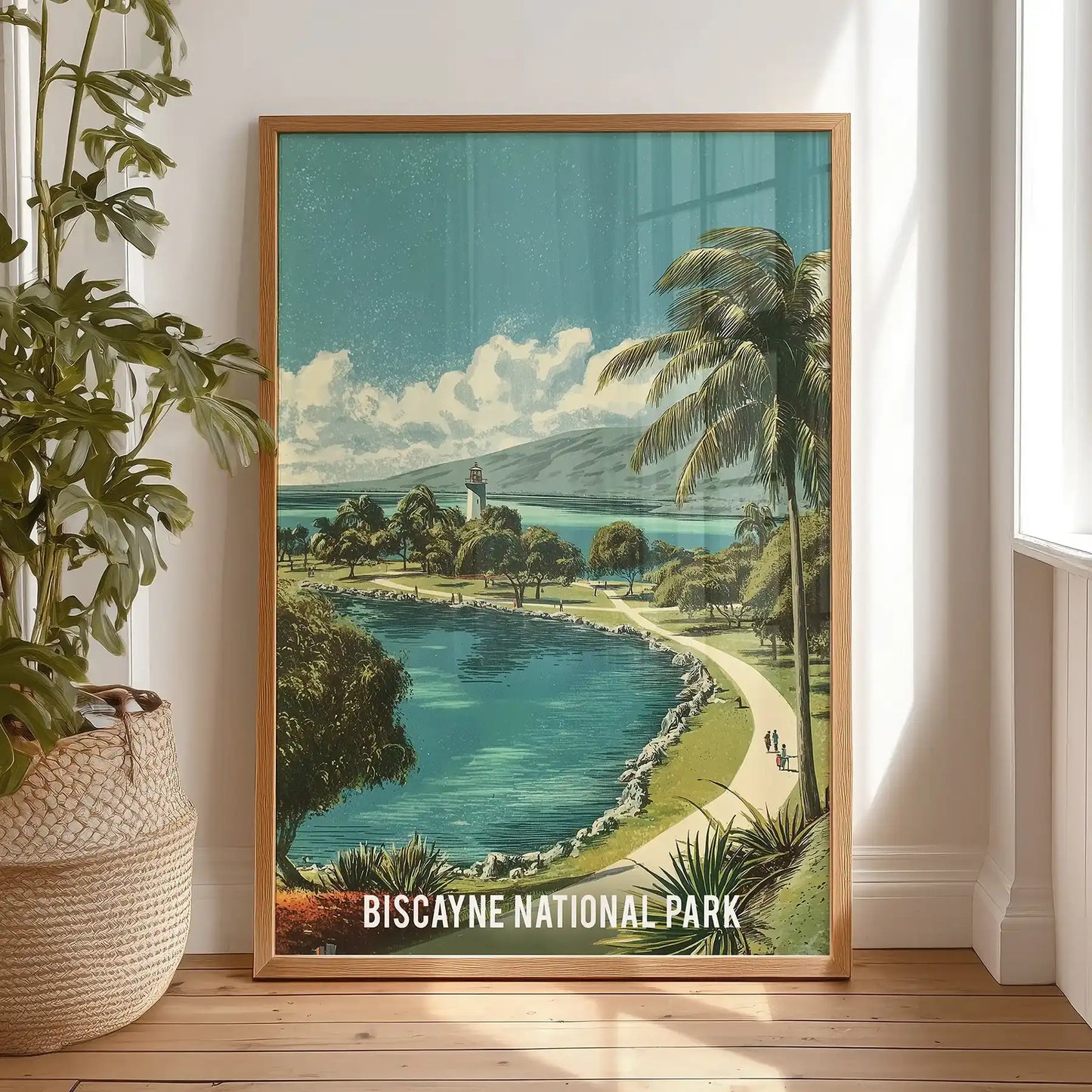 Light-oak framed wall decor shows a lush green bay, propped in a bedroom for relaxed style with glossy waters and palm-lined shallows.