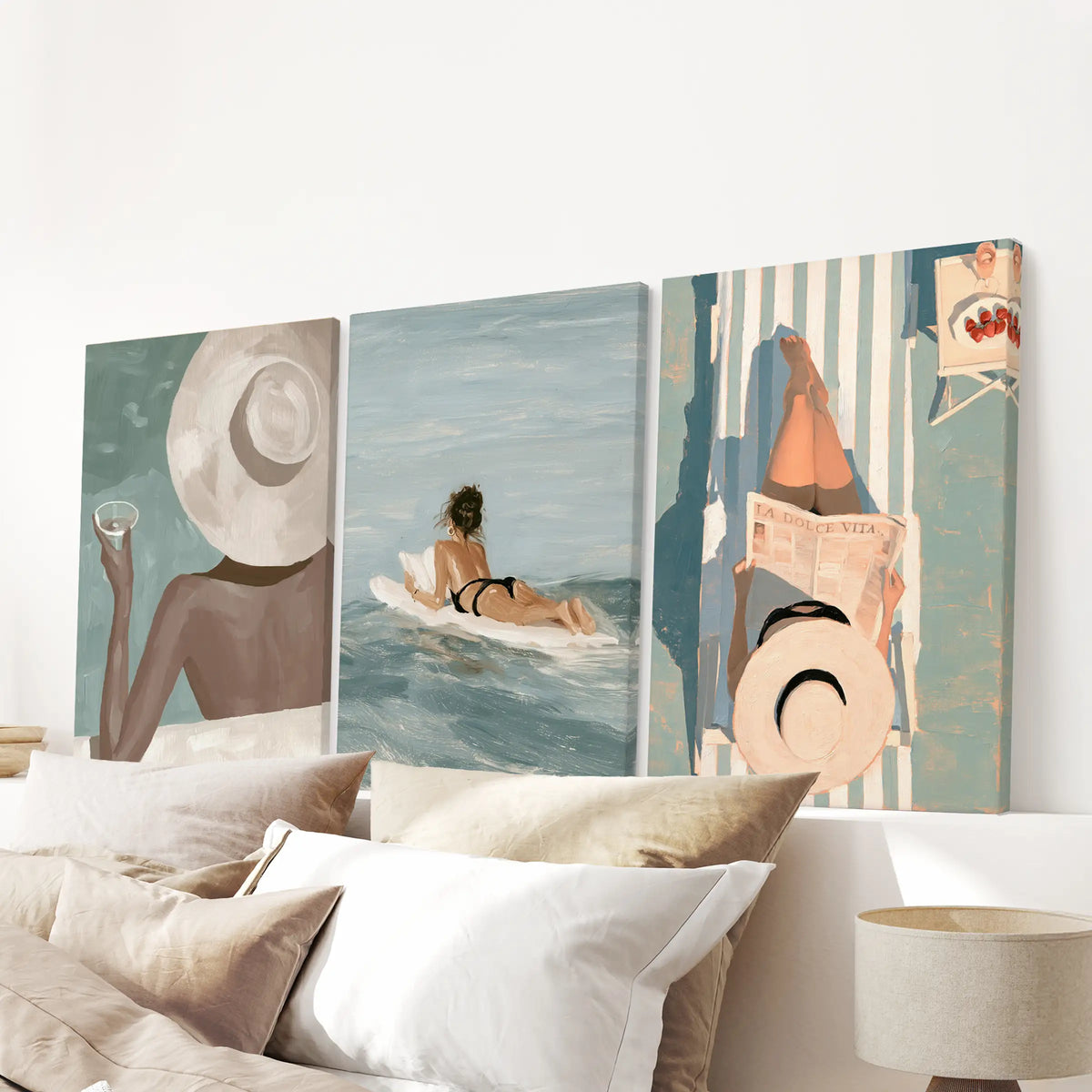 Coastal fashion 3-print gallery wall features canvas prints arranged over the bed in a bedroom.