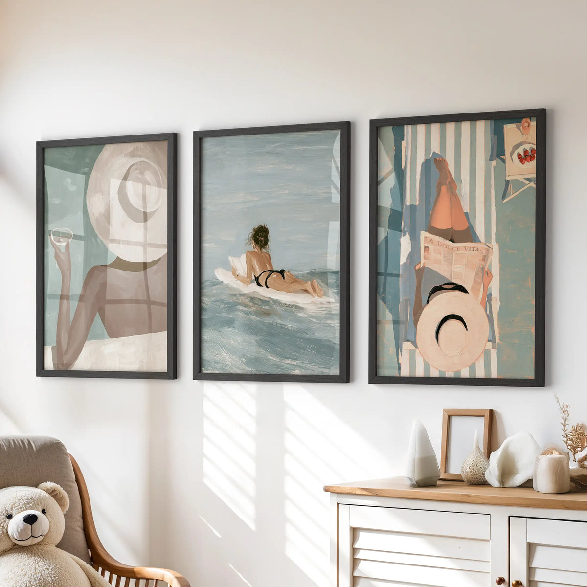 Coastal fashion three-piece wall art set in black frames, mounted above a dresser in a kids' playroom.