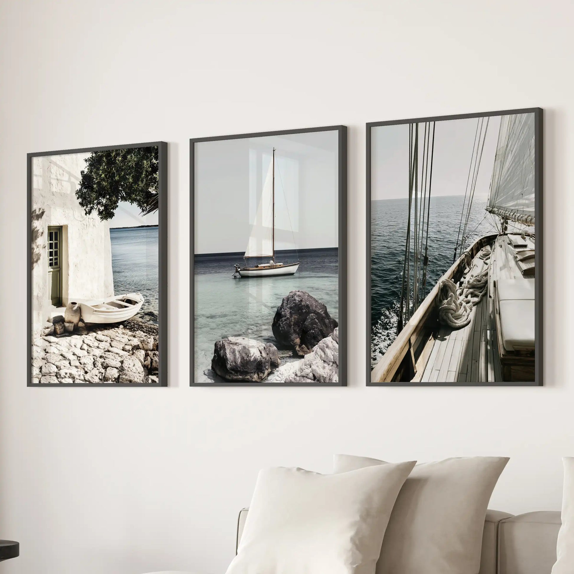 Wall art in a 3-piece yacht photography set is arranged above the sectional, with black-framed prints giving the lounge a cool, modern coastal tone.