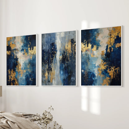 Blue and gold oil paint textures in a 3-piece picture set with slim white frames hang near the bedroom bed wall, creating crisp, upscale wall decor.