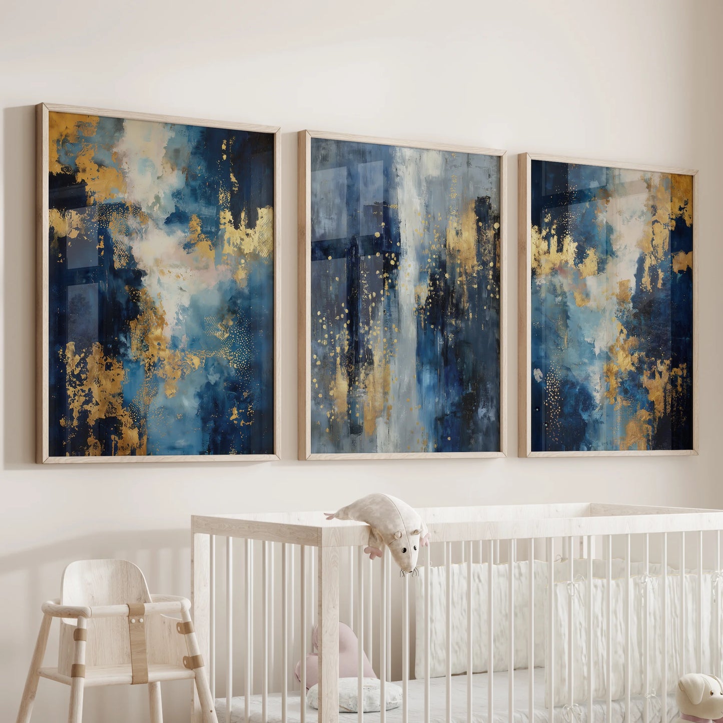 A 3-piece wood-framed picture set in modern navy abstracts decorates the wall above the crib, keeping the baby room calm and polished.