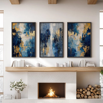 Abstract navy and gold brushstrokes in a set of 3 large black-framed wall art prints anchor the sitting room over the fireplace mantel with a luxe modern tone.