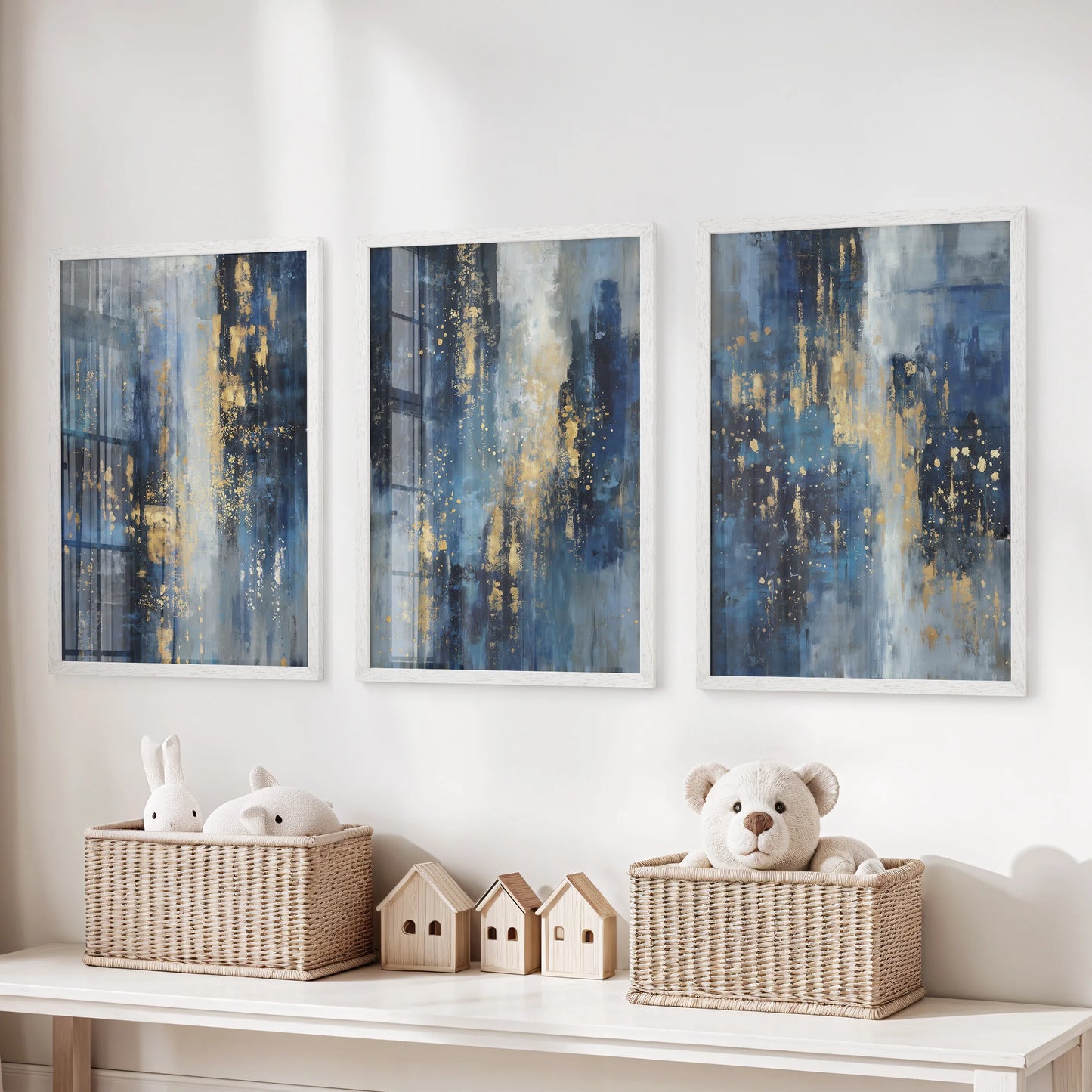 Three white-framed wall art prints in blue-and-gold tones hang over the toy storage bench, adding artful glow to the kids playroom.