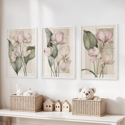 Pink petals and dark green leaves overlap cream panels and fine geometric lines in three white-framed prints above toy baskets.