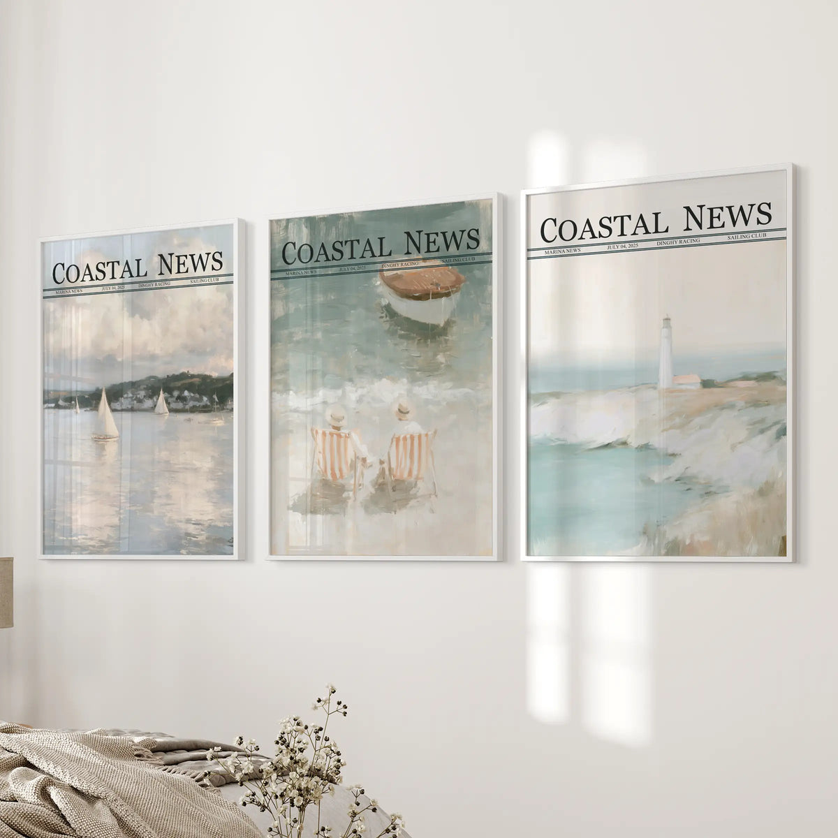 Three-piece seaside wall art set in white frames, displayed together next to a bed in a bedroom.