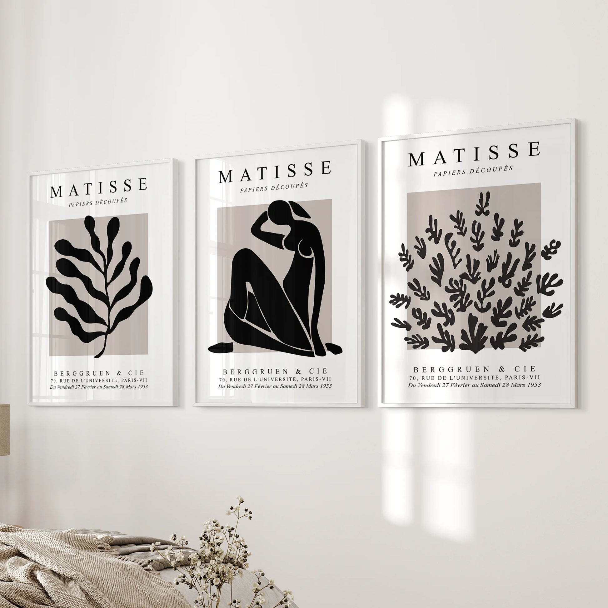 Three white-framed Matisse cut-out prints hang beside the bed, giving the bedroom a calm focal point.