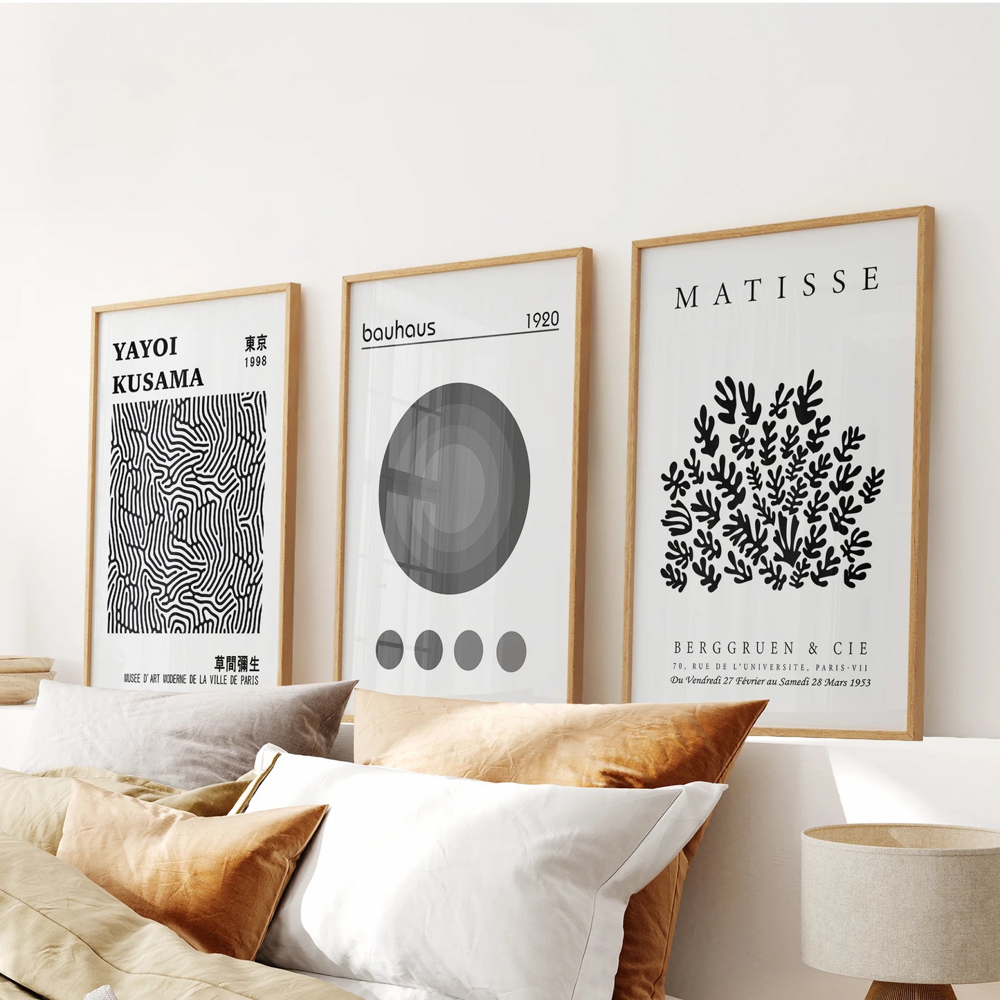 Matisse cut-out prints, set of three in warm oak frames, accent the bedroom above the headboard with soft, sculptural charm.