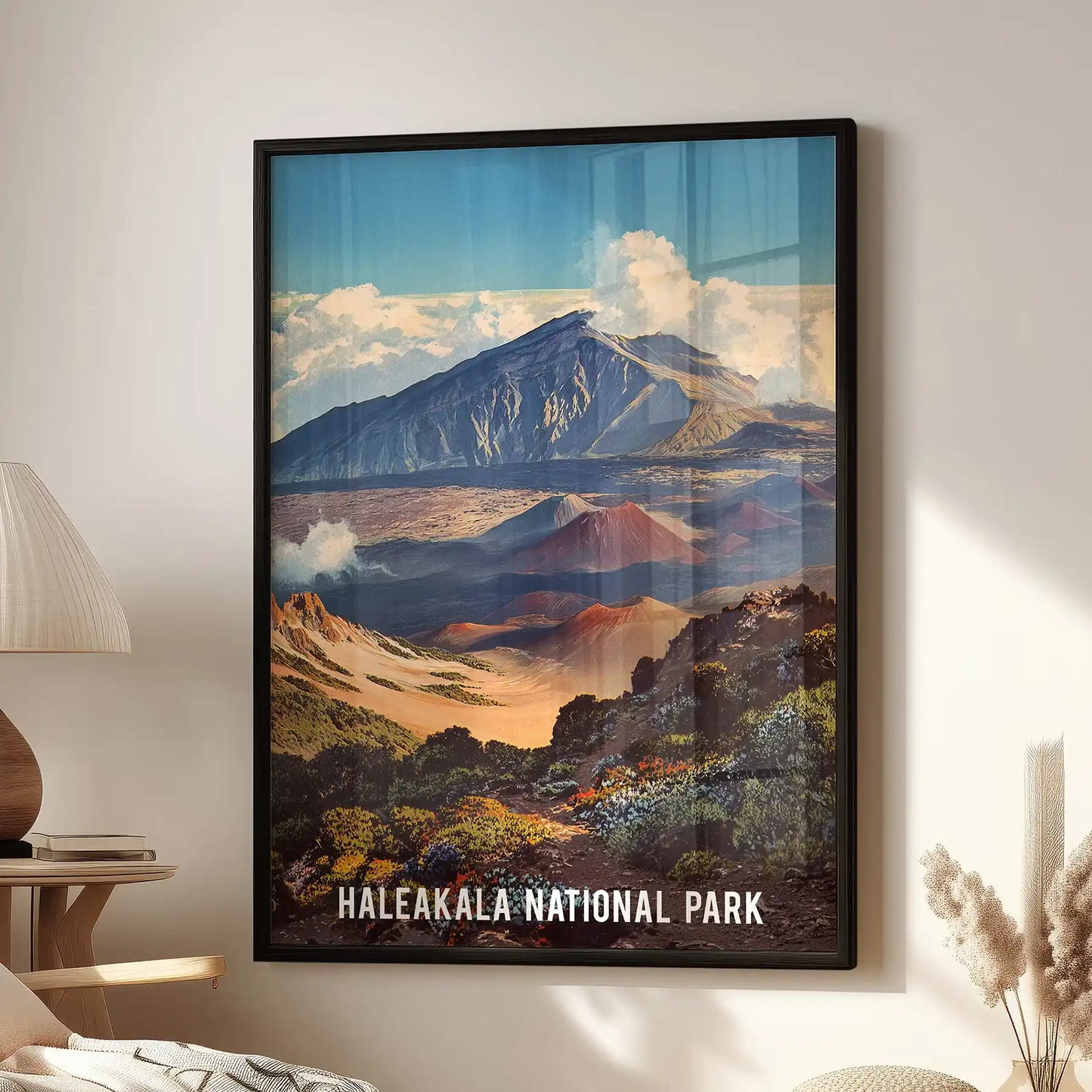 Wall art print of Haleakalā National Park grounds the sitting room beside an accent chair, its sleek black frame showcasing Maui’s volcanic panorama.