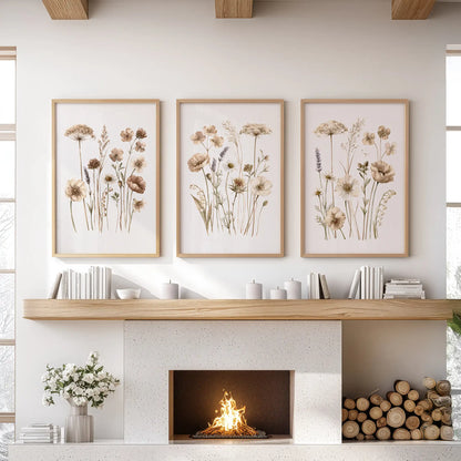 Three prints depict slender meadow stems with beige and brown flowers, in oak frames above a fireplace.