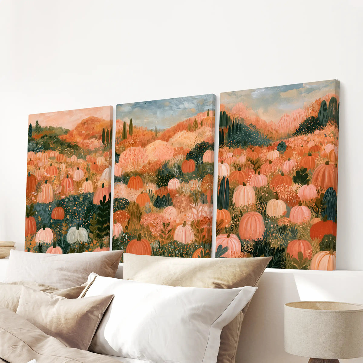 A 3-piece canvas artwork set portrays a pastel pumpkin field with gallery wraps, hanging above the bedroom headboard for a serene cottagecore finish.