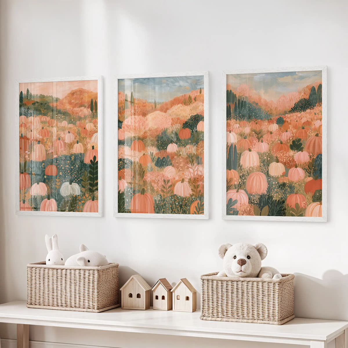 Folk art pumpkins, a three-piece print set in white frames, brightens the playroom above the storage bench with friendly color and harvest charm.