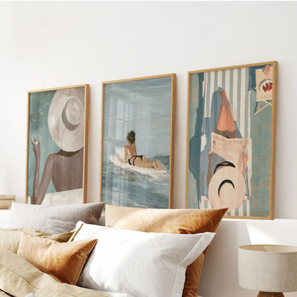 Mediterranean resort set of three art prints in wood frames, mounted above the headboard in a bedroom.