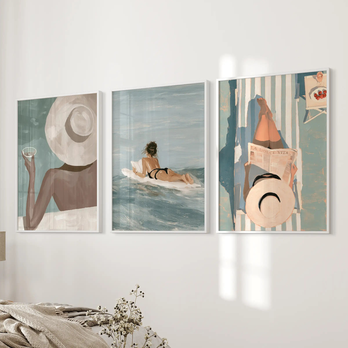 Mediterranean resort set of 3 wall decor prints is shown in white frames on a bedroom wall beside the bed.