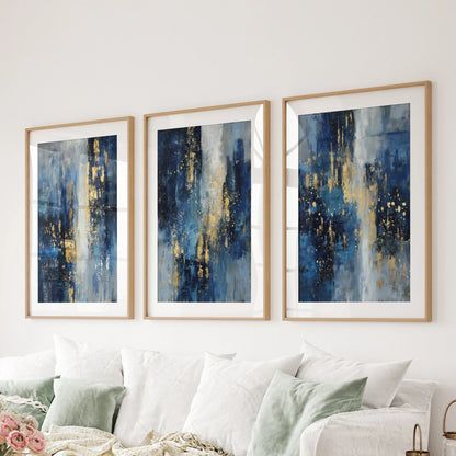 A three-panel blue and gold abstract set in natural wood-matted frames anchors the lounge wall above the sofa with modern balance.