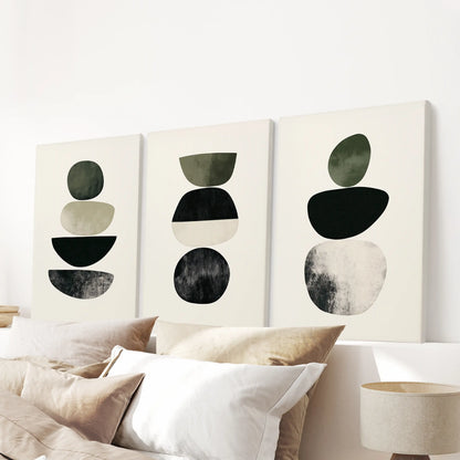 A mid-century abstract wall art trio on wrapped canvas spans the space above the bed’s headboard, delivering a cohesive, modern accent.