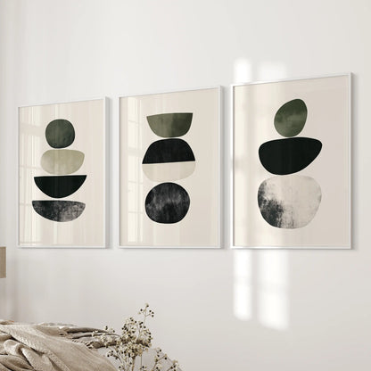 Organic shapes in a neutral palette three-print set offers quiet wall art for the bedroom, finished with white frames on the wall beside the bed.