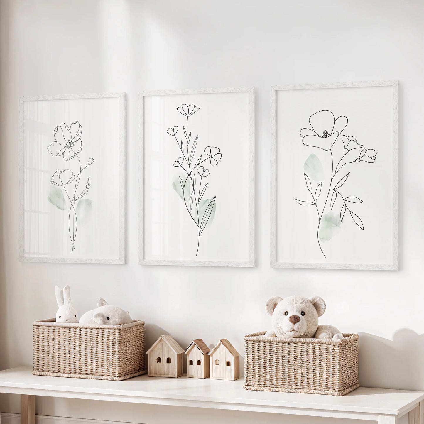Watercolor floral botanicals in a set of three wall art prints brighten the kids room, white frames keeping the palette light while the blooms stay playful yet refined.