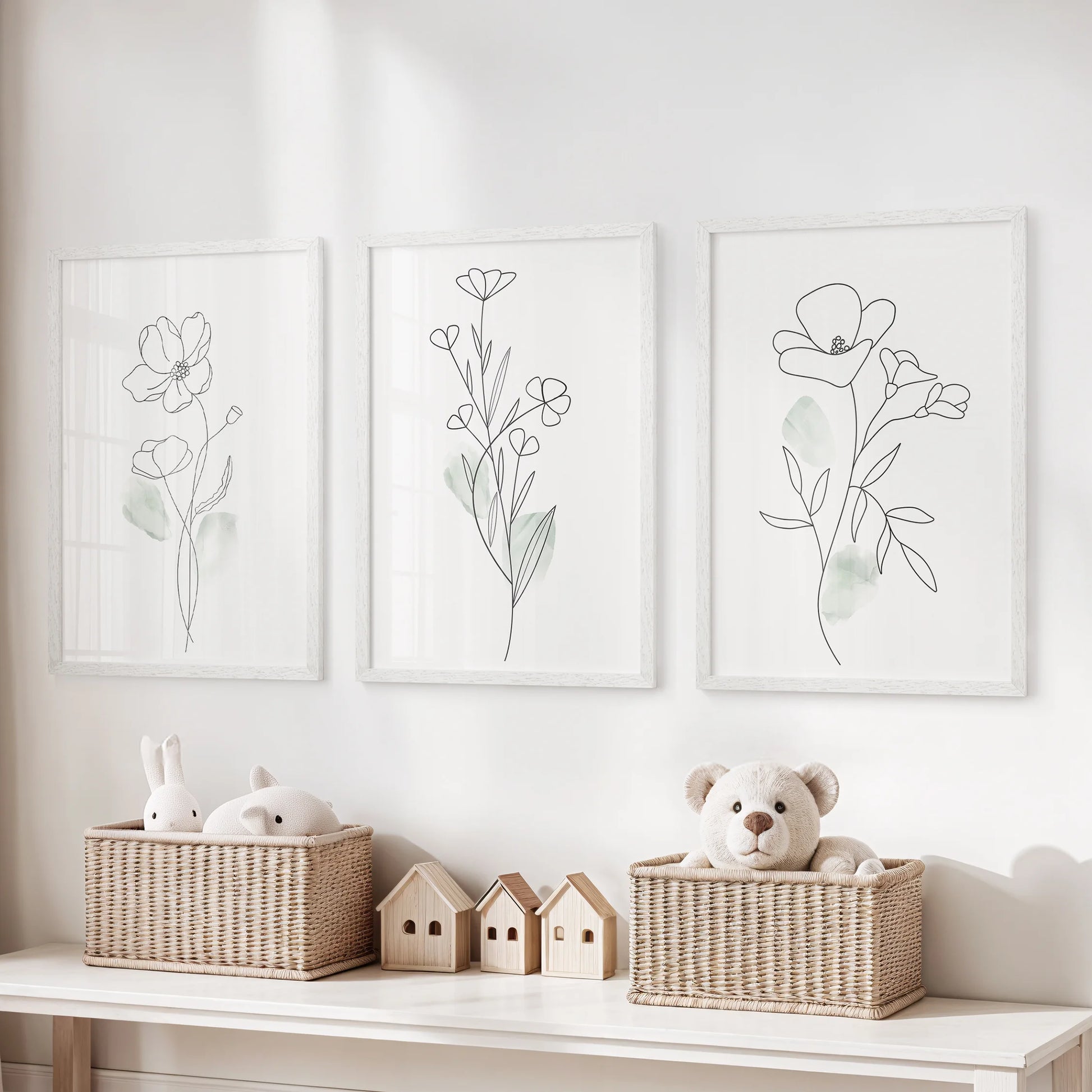 Watercolor floral botanicals in a set of three wall art prints brighten the kids room, white frames keeping the palette light while the blooms stay playful yet refined.