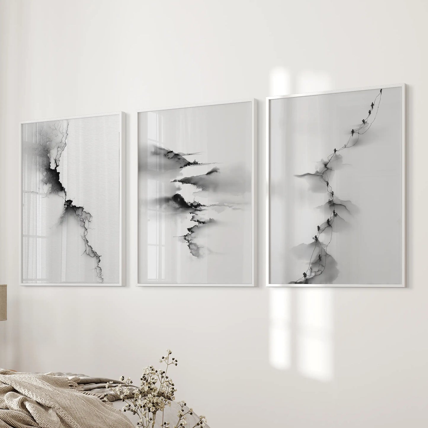 Three minimalist landscape posters in airy white frames arrange beside the bed, keeping the bedroom wall balanced and calm.