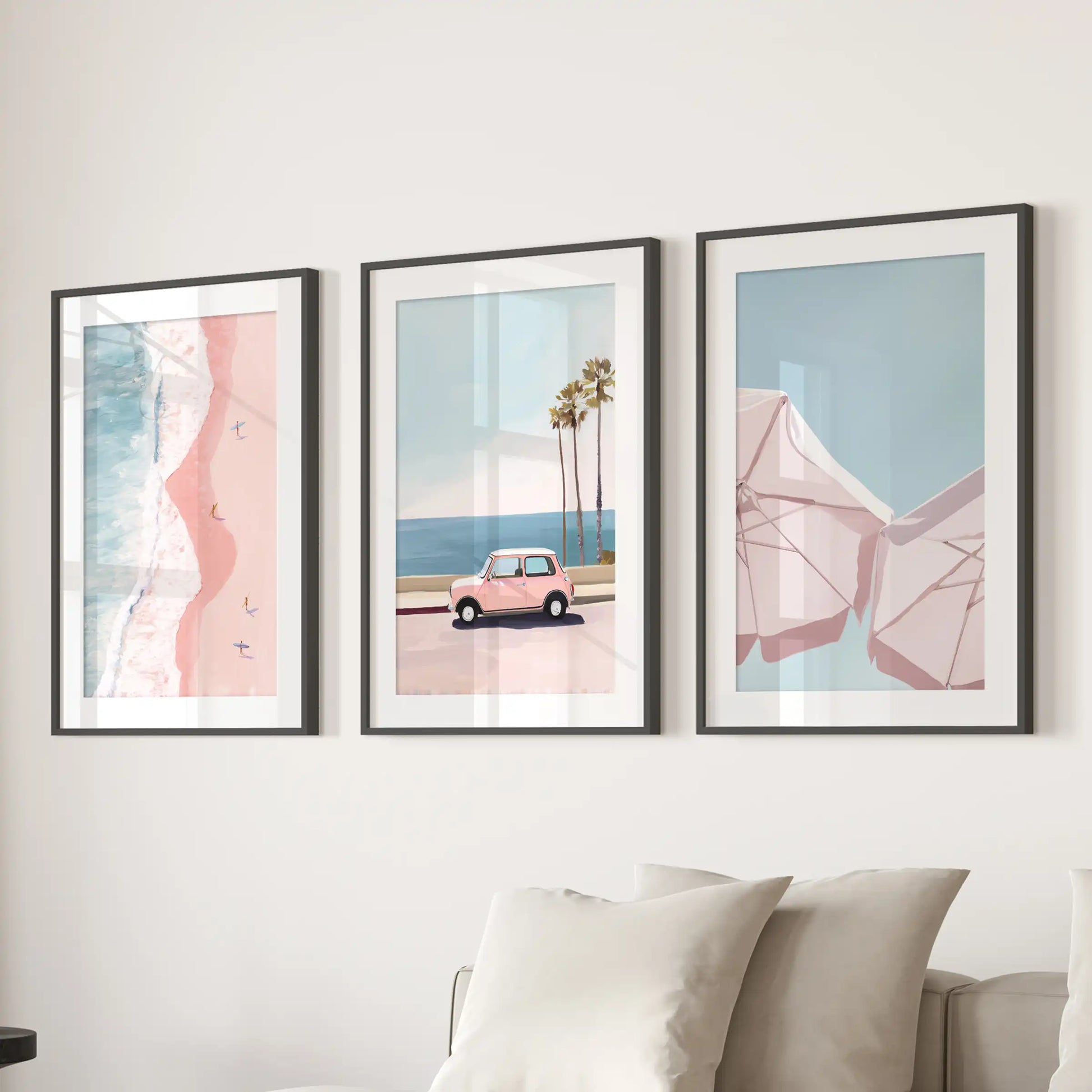 Vintage beach car, a wall art three-piece in black frames with matting, parks a pastel coastal vibe over the couch in the family room.