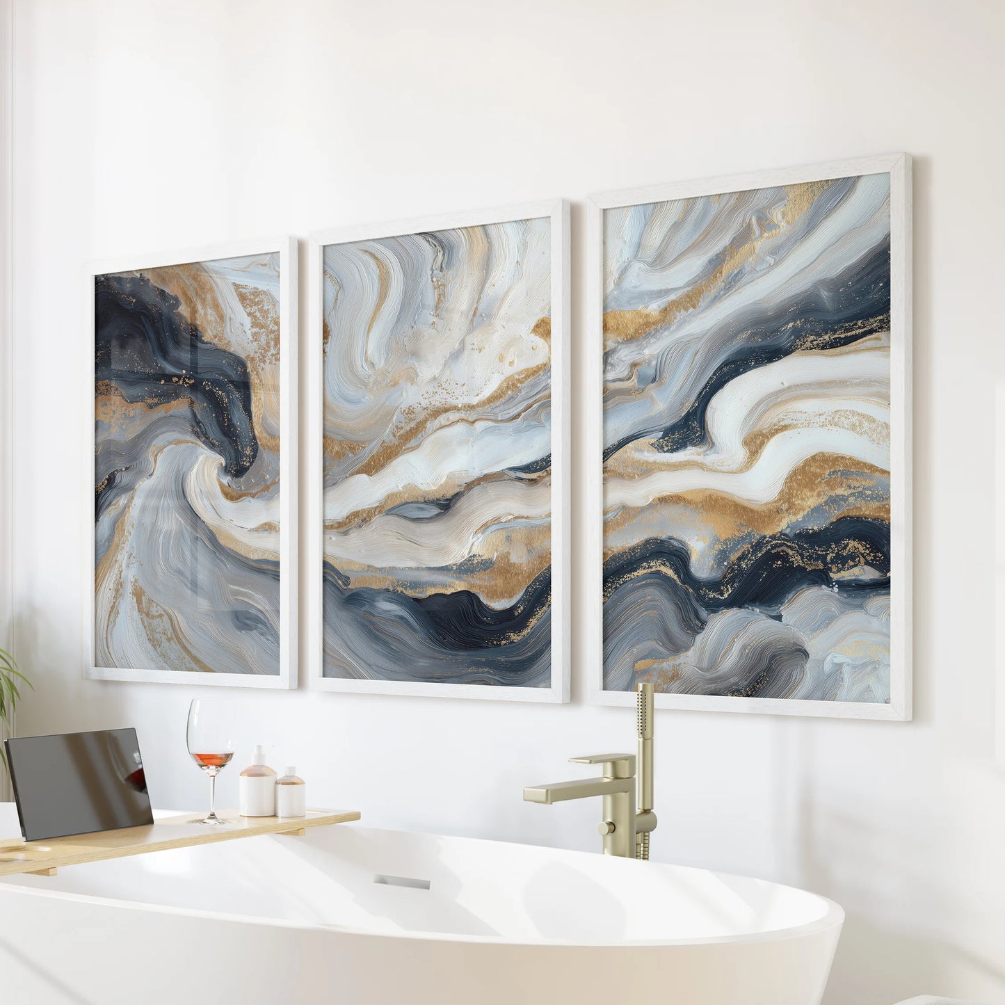 Navy blue brush stroke abstracts, a wall art set of three, bring spa-calm to the bathroom in crisp white frames hung over the bathtub.