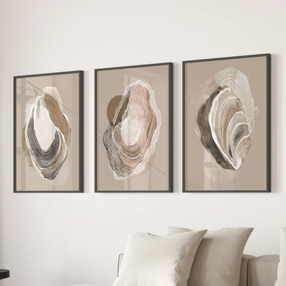 Three vintage marine shell studies, each black framed, form a crisp gallery-style display over the lounge couch for a cool coastal note.