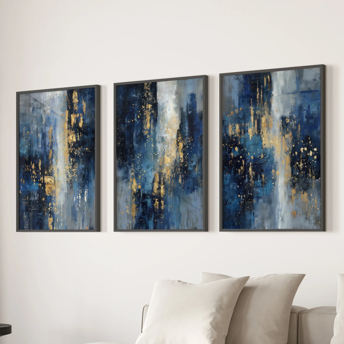 Contemporary oil textures in blue and gold, 3-piece art set, in slim black frames placed behind the couch to ground a relaxed family room.