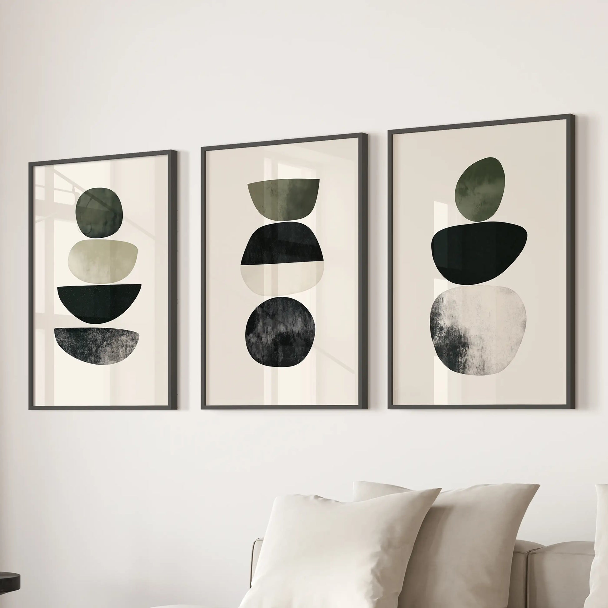 Organic shapes in a neutral palette three-print triptych adds calm wall art to the sitting room, black framed and composed to float over the couch.