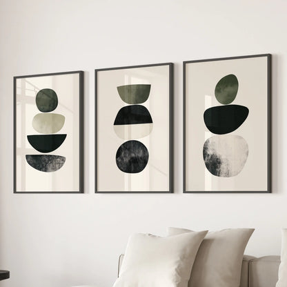 Organic shapes in a neutral palette three-print triptych adds calm wall art to the sitting room, black framed and composed to float over the couch.