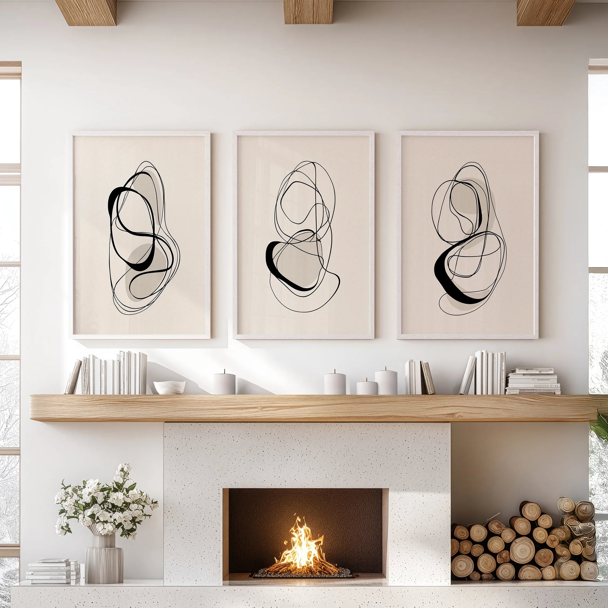 Contemporary line illustrations, a print trio set in white frames, placed over the mantelpiece to give the sitting room a refined, minimalist edge.