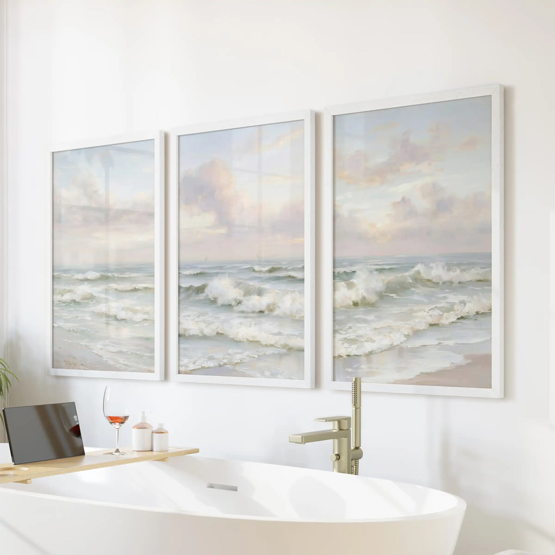 Gentle surf and tide, an art set of 3 in crisp white frames, turns the bathroom serene when mounted over a freestanding tub.