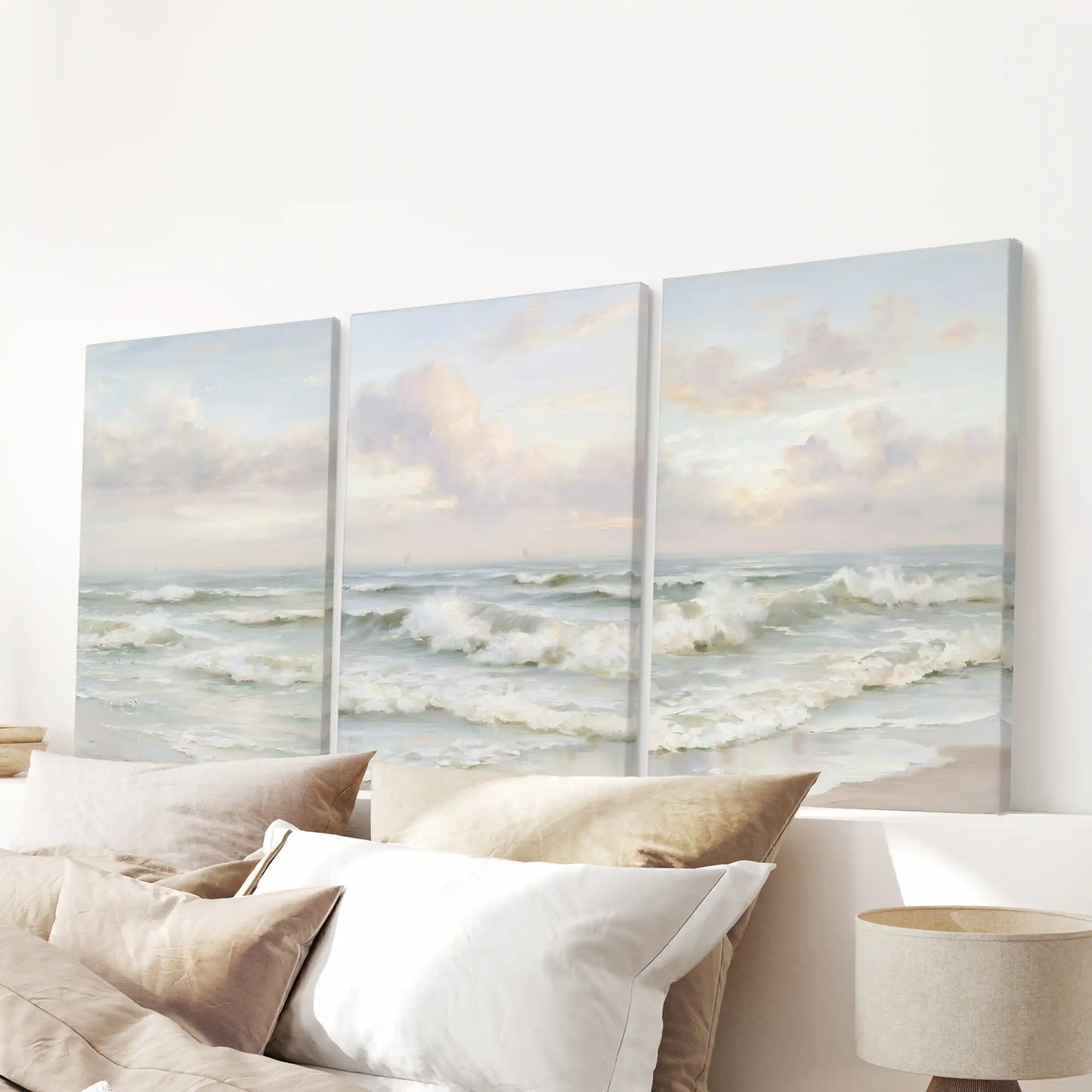 Three gallery-wrapped ocean posters serve as minimalist wall art, centering the bedroom’s look above the headboard.