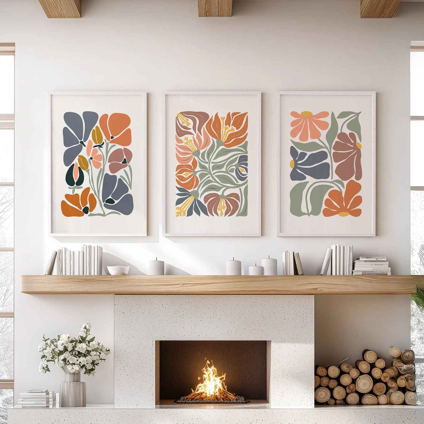 White-framed vintage floral art in a composed set of three centers the family-room hearth with warmth and simple negative space.