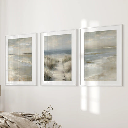 Dune grass shoreline set of three wall art prints with white mats and frames lends a restful, seaside feel across the bedroom wall.