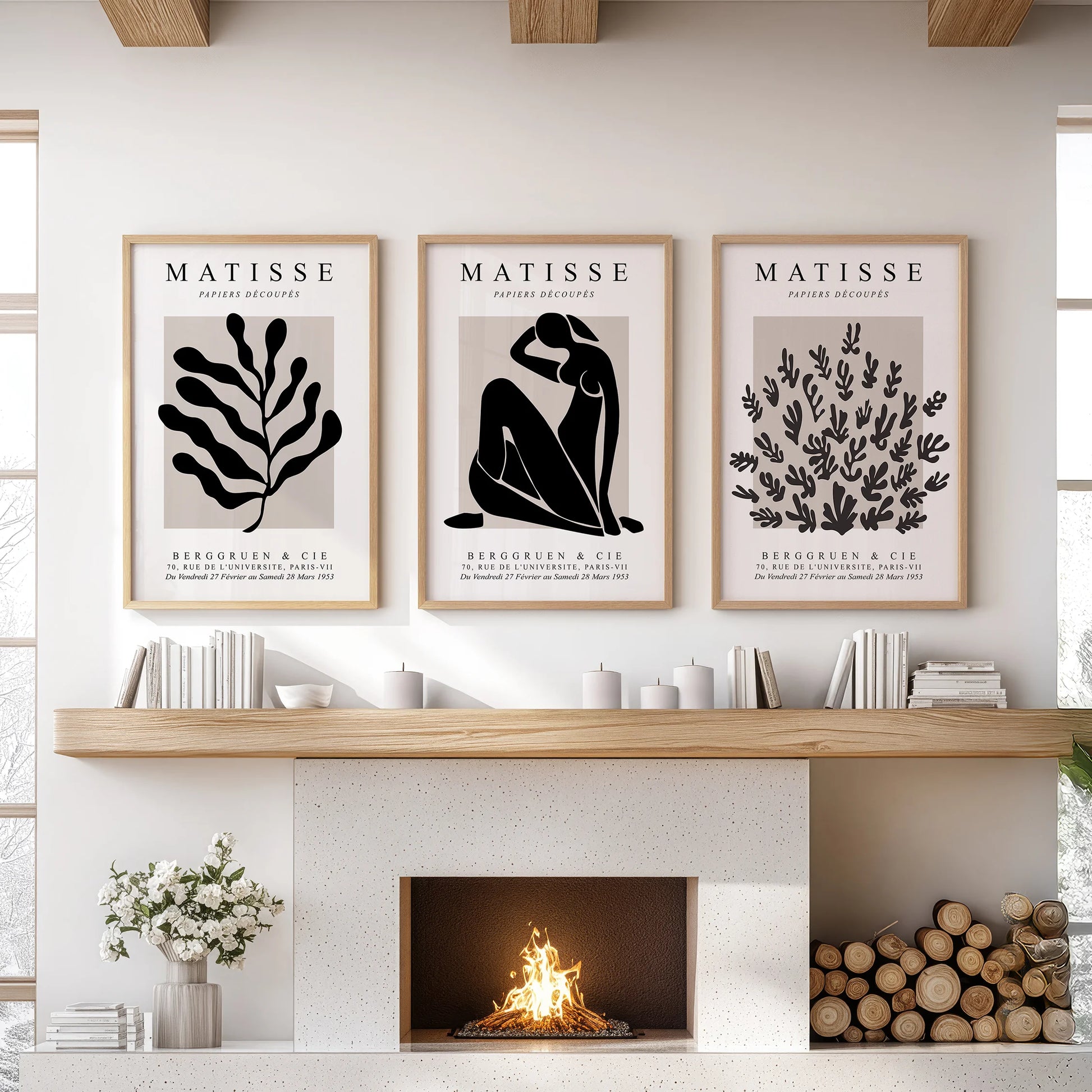 Mid-century modern art, a three-piece wall art set in warm wood frames, anchors the sitting room wall over the mantel.
