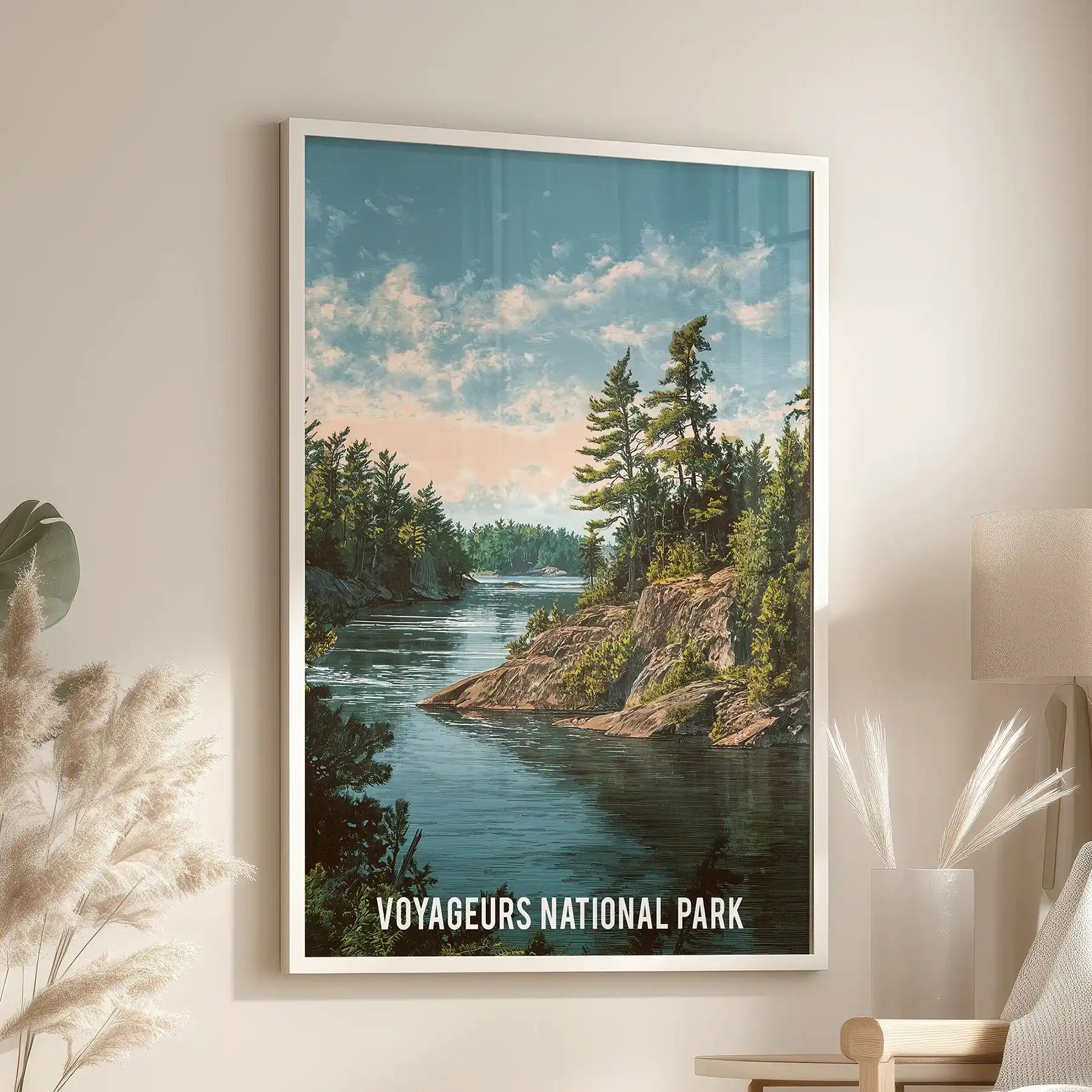 Forested shoreline in deep teal tones, a single wall print in a white frame sits above a lounge chair in the living room.