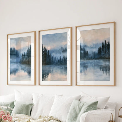 Misty forest lake wall art, arranged as three pieces in light wood matted frames, anchors the lounge above the sectional with hushed shoreline blues.