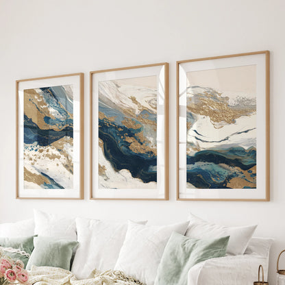 A wall hanging set of three abstract prints spans the space above the living room couch, their oak frames and soft mats bringing earthy balance.