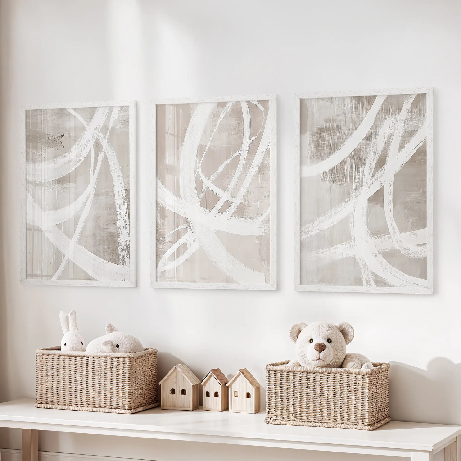 Modern abstract forms prints, set of 3 in bright white frames, hang over the toy organizer to bring tidy structure to the kids’ room.