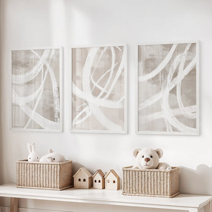 Modern abstract forms prints, set of 3 in bright white frames, hang over the toy organizer to bring tidy structure to the kids’ room.